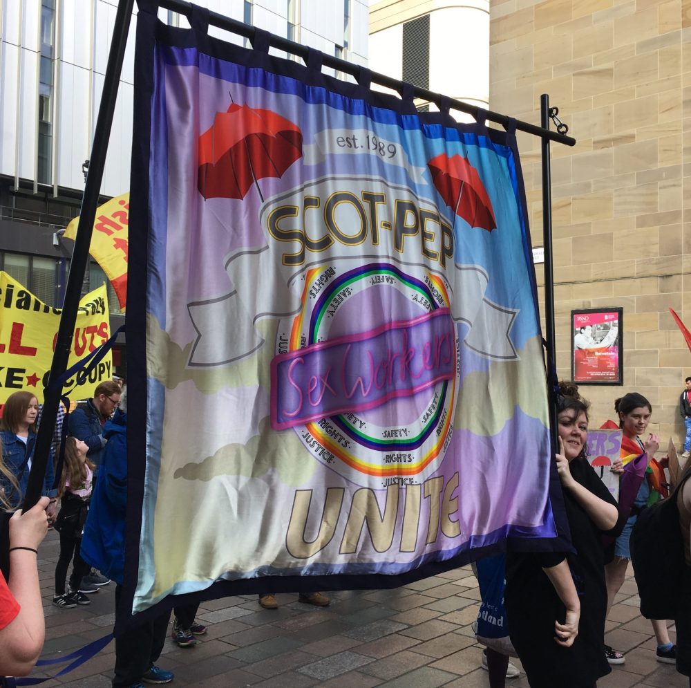 SCOT-PEP banner at a protest